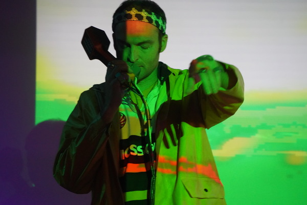 photo of Ericson, TM performing in neon light